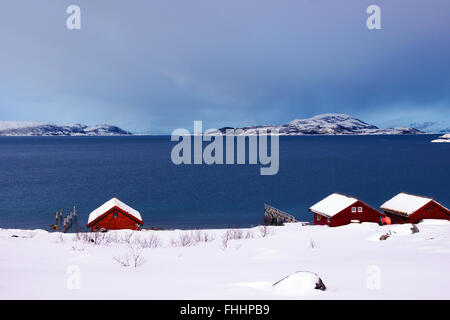 Wooden fisher cottages by a fjord in Northern Norway. Stock Photo