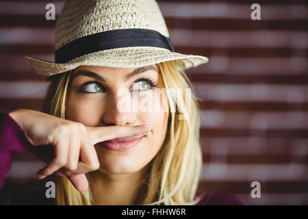 Blonde woman having a fake mustache Stock Photo - Alamy