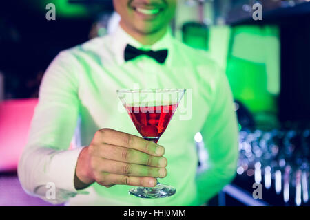 Bartender serving glass of cocktail Stock Photo