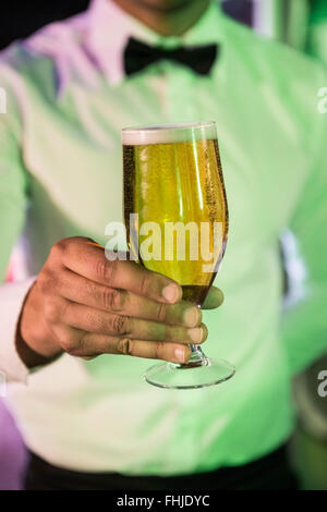 Close-up of bartender serving glass of beer Stock Photo