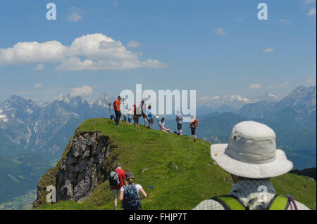 Hikers enjoying a panoramic mountain view from the Karstein peak (1922m). Kitzbuehel. Tyrol. Austria. Stock Photo