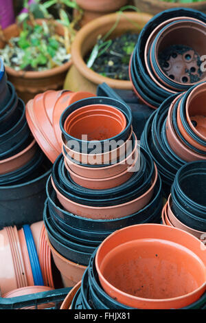 Assorted flower pots in a garden Stock Photo