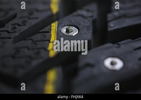 Studded tire on a gray background Stock Photo