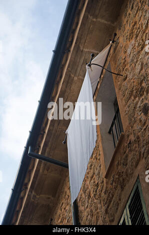 Mallorca, Balearic Islands, Spain: a white curtain on a balcony in Fornalutx, a mountainous municipality in the Soller district Stock Photo