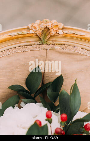 Details of vintage terracotta chair with wedding bouquet close up Stock Photo