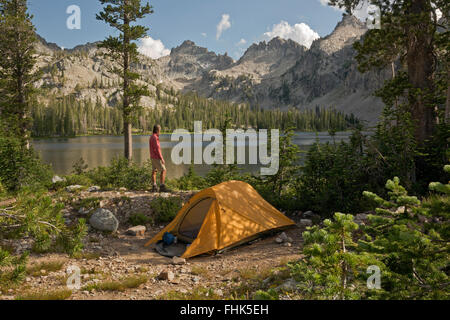 ID00431-00...IDAHO - Hiker at campsite at Alice Lake in the Sawtooth Wilderness Area. Stock Photo