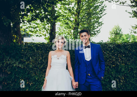 Beautiful wedding couple posing in the park Stock Photo