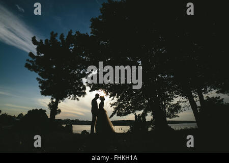 bride groom standing in the park Stock Photo