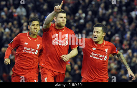 Liverpool, UK. 25th February, 2016. Liverpool's Roberto Firmino (L-R), James Milner und Philippe Coutinho celebrate after Milner scored the opening goal during the UEFA Europa League round of 32, second leg soccer match between Liverpool FC and FC Augsburg in Anfield, Liverpool, England, on 25 February 2016. Credit:  dpa picture alliance/Alamy Live News Stock Photo