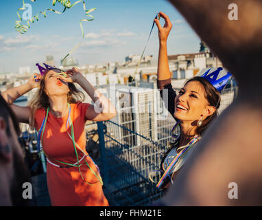 Austria, Vienna, Young people having a party on rooftop terrace Stock Photo