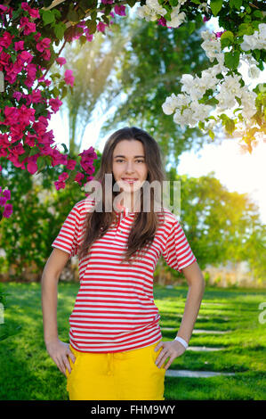 beautiful sensuality young girl on a background of flowers Stock Photo