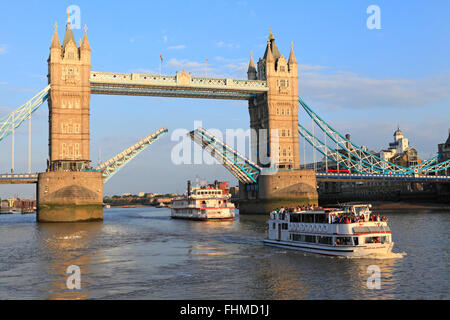 Tower Bridge open for pleasure boats to pass through at sunset, on the River Thames, London, England, GB, UK Stock Photo