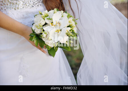 Bride holding a beautiful white bouquet Stock Photo