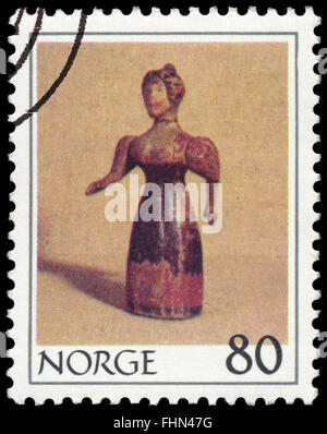 BUDAPEST, HUNGARY - 21 february 2016: a stamp printed in the Norway shows Wooden woman, circa 1978 Stock Photo