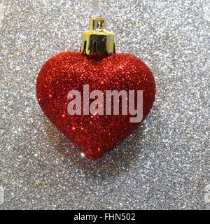 one lone red heart in the glitter silver background Stock Photo