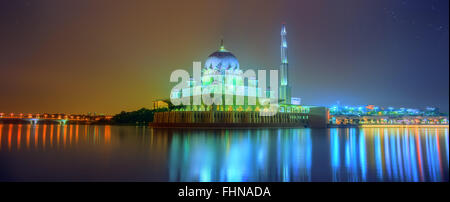 Sunset over Putrajaya Mosque and Panorama of Kuala Lumpur, Malaysia. Stock Photo