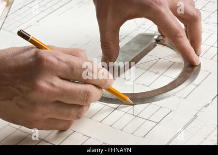 hand draws a pencil on drawing Stock Photo