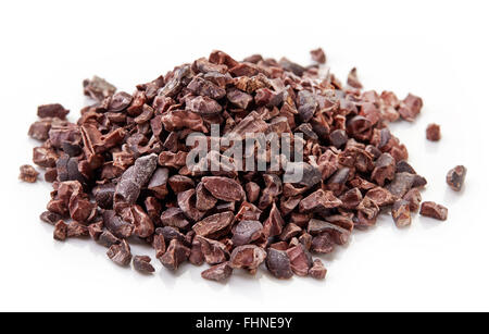Heap of cacao nibs, isolated on white background Stock Photo