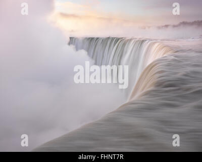 Brink of Niagara Falls Canadian Horseshoe beautiful sunrise scenery in soft light pastel colors, wintertime scenic. Niagara Fall Stock Photo