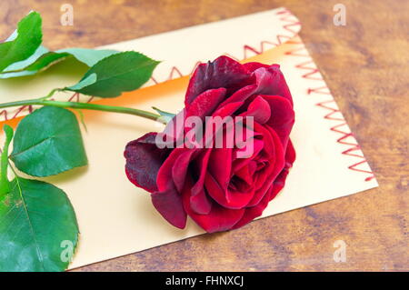 Red rose on a romantic handmade love envelope Stock Photo