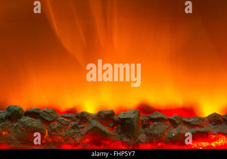 Electric fireplace with a burning coals and red-orange background Stock Photo