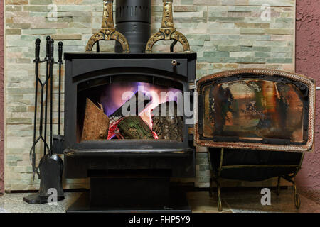 Old fireplace with a burning firewoods Stock Photo