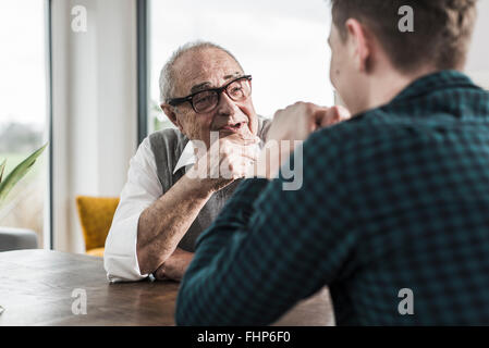 Portrait of happy senior man communicating with his grandson Stock Photo