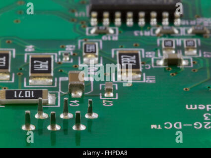 Detail of an electronic printed circuit board with many electronic components Stock Photo