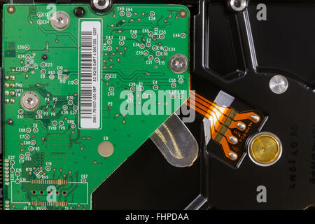 Close-up inside a hard disk showing the printed circuit board and the connection to its mechanical parts Stock Photo