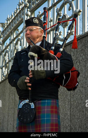 EDINBURGH, SCOTLAND, - MARCH 4: Unidentified Scottish Bagpiper playing music with bagpipe at Edinburgh on March 4, 2010. Edinbur Stock Photo