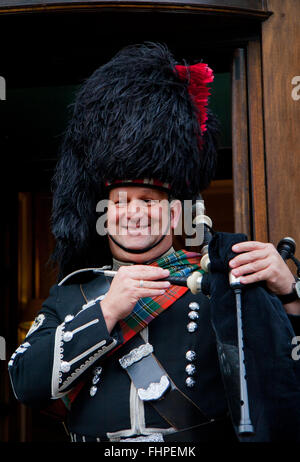 EDINBURGH, SCOTLAND, - MARCH 6: Unidentified Scottish Bagpiper playing music with bagpipe at Edinburgh on March 6, 2010. Edinbur