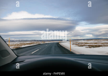 On the road, driving on an empty road across snow covered Iceland Stock Photo