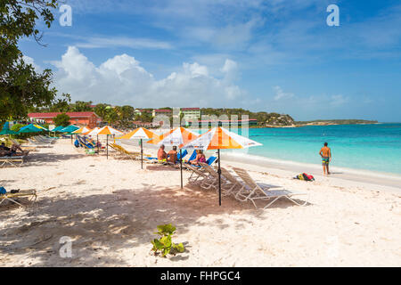 Long Bay, a beautiful popular sandy beach on the east of Antigua, Antigua and Barbuda, West Indies, with sunbeds and parasols Stock Photo