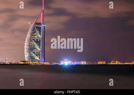 Dubai, United Arab Emirates - Dec 2, 2014 : View of the illuminated Burj Al Arab at the sunset. View from the Jumeirah beach. Bu Stock Photo