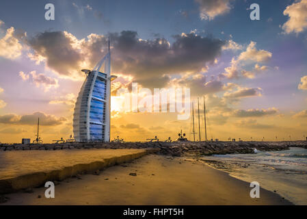 Dubai, United Arab Emirates - Dec 2, 2014: View of the illuminated Burj Al Arab at the sunset,  from the Jumeirah beach. Burj Al Stock Photo