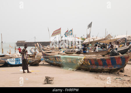 ACCRA, GHANA - JANUARY 2016: A fisherman preparing the net on his fishing boat in Jamestown, Accra, Ghana Stock Photo