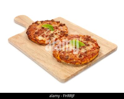 Mini Pizzas isolated on a kitchen bench Stock Photo