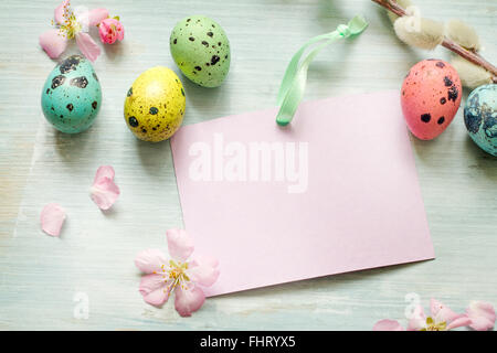 Easter eggs, willow twigs and blank paper card background concept Stock Photo