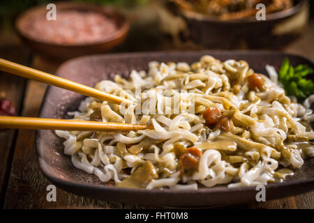 Bowl of noodles with green curry sauce Stock Photo