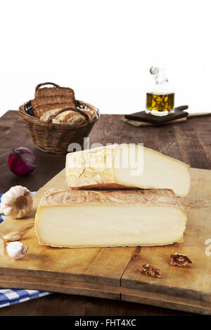 Cheese pieces with bread on wooden board. Stock Photo