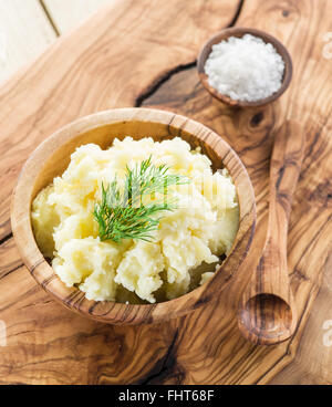 Mashed potatoes in the wooden bowl on the service tray. Stock Photo