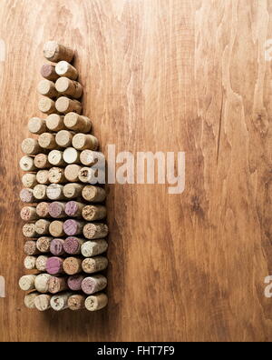 Wine corks in the shape of wine bottle on the wooden background. Stock Photo