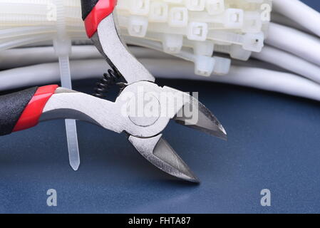 Pliers with cables and bunch of cable ties Stock Photo
