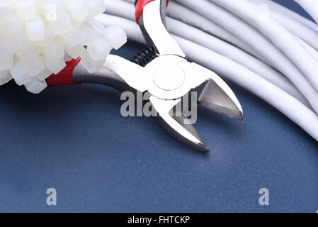 Pliers with cables and bunch of cable ties Stock Photo