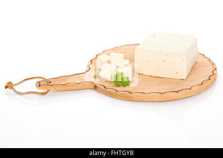 Delicious tofu isolated on cutting board. Stock Photo