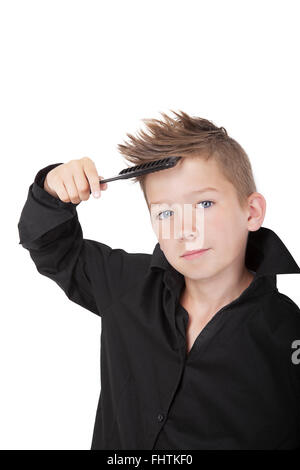 Boy brushing hair. Stock Photo