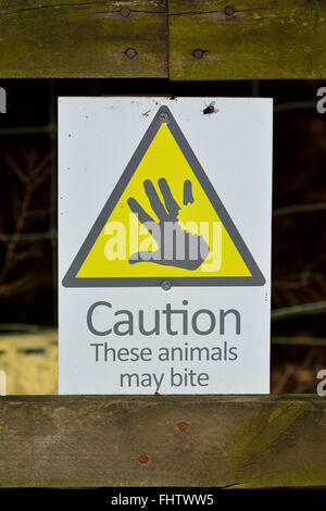 A warning sign that these animals may bite Stock Photo - Alamy