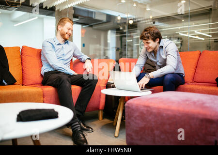 Business colleagues talking during break and working Stock Photo