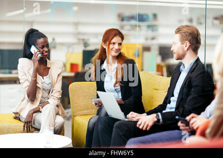 Business people conversation with technology at hand. Exchange of new ideas and brainstorming between colleagues Stock Photo