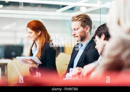 Business people conversation with technology at hand. Exchange of new ideas and brainstorming between colleagues Stock Photo